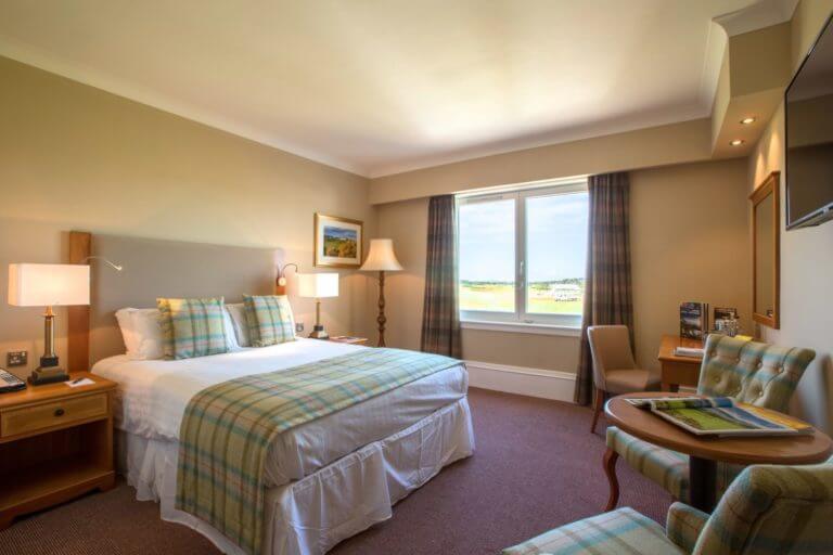 Spacious bedroom with large bed in Carnoustie Golf Hotel