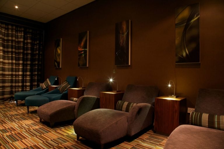 Dark lounge room fitted with couches at Carnoustie Golf Hotel