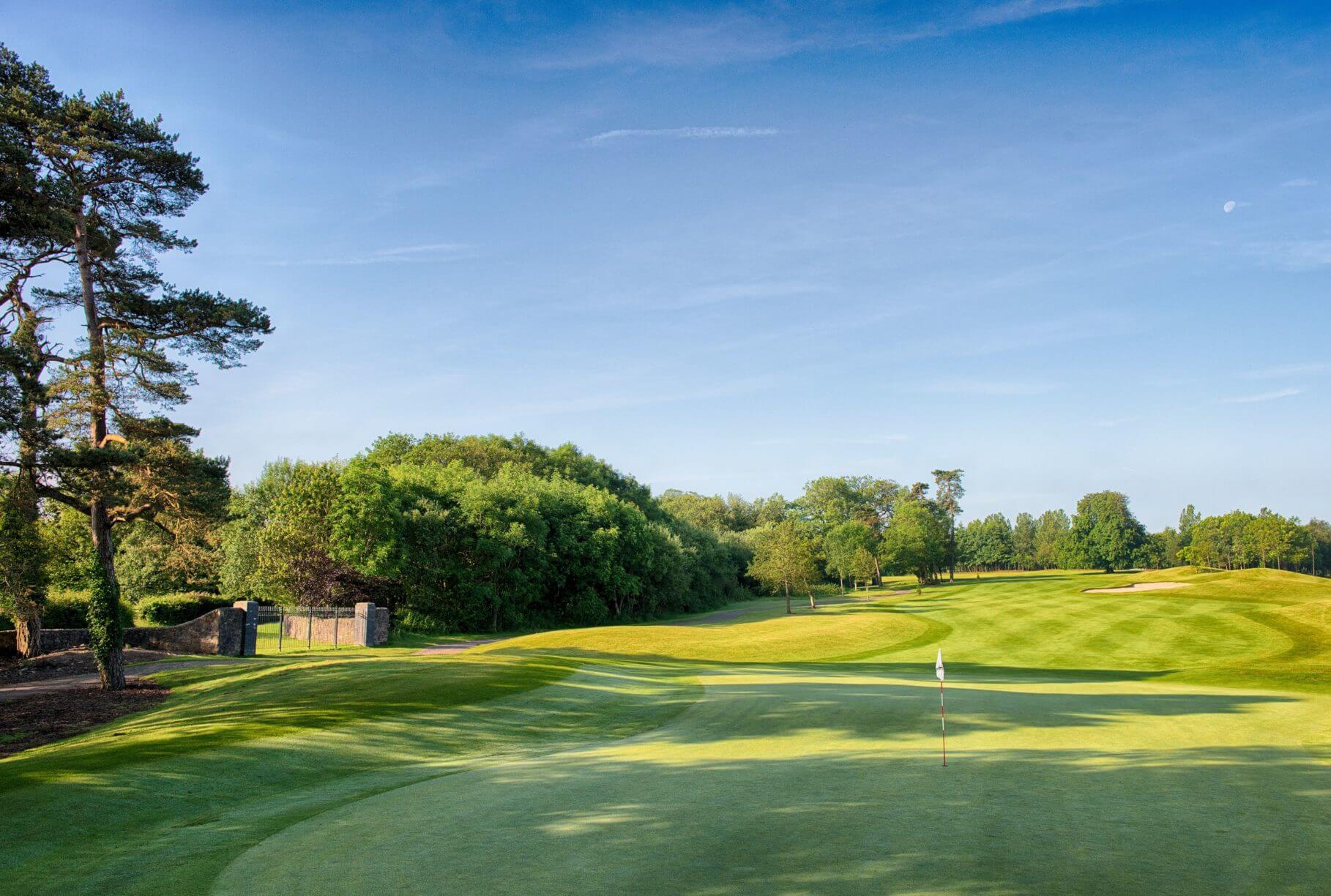 Sun beams on a fairway at Vale Resort in Wales