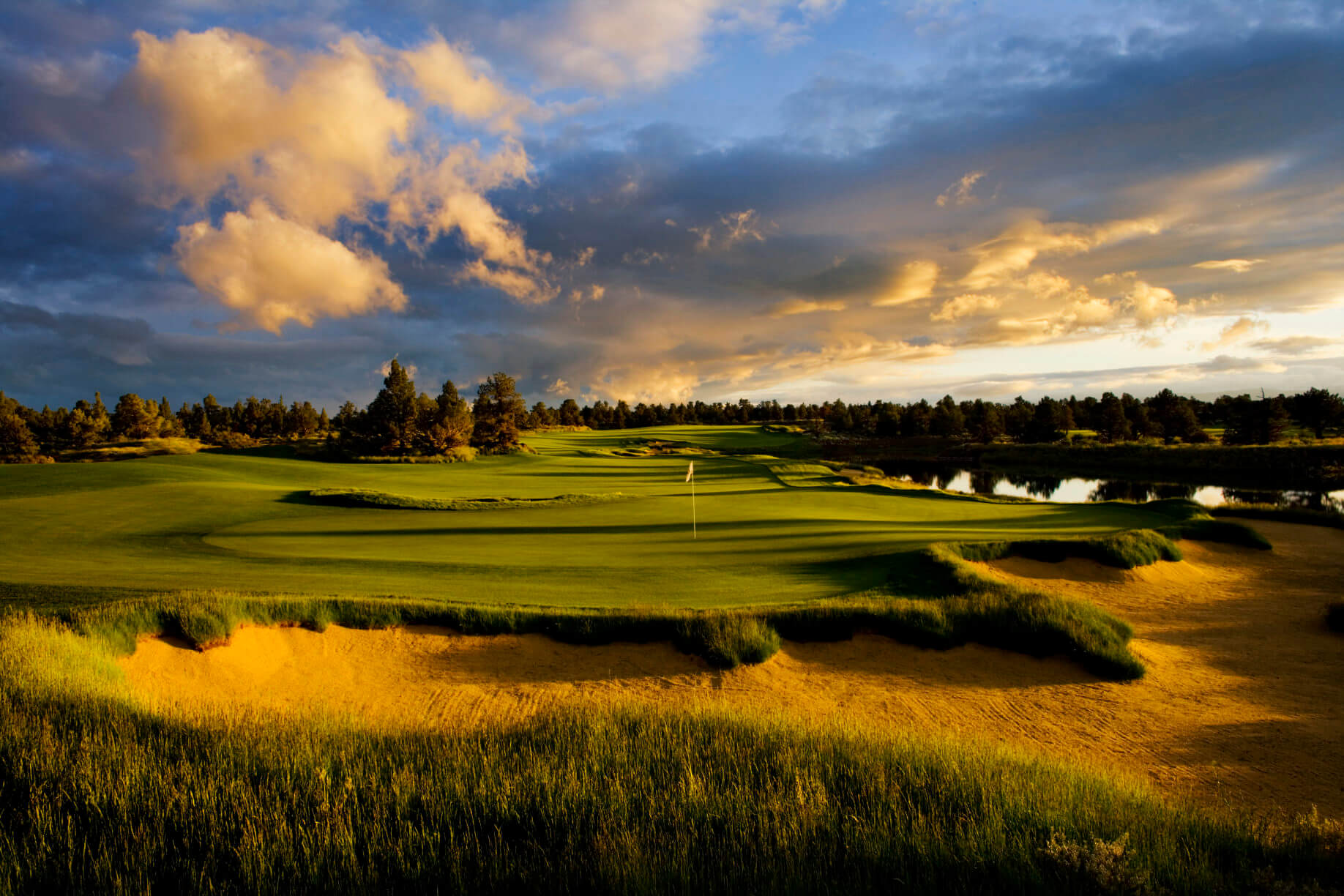 Sun sets over a green at Pronghorn Golf Resort