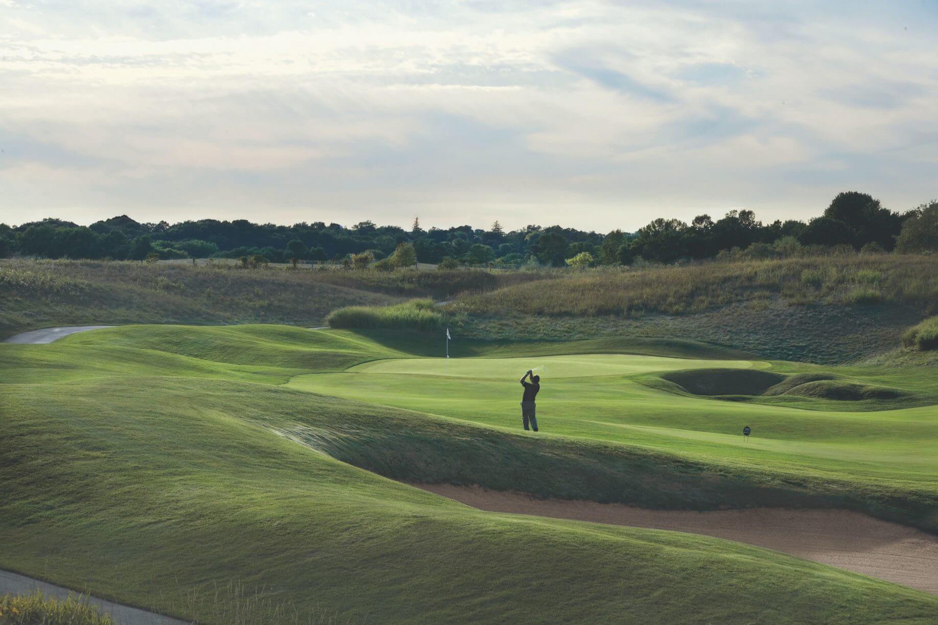 Man plays golf at The Irish Course
