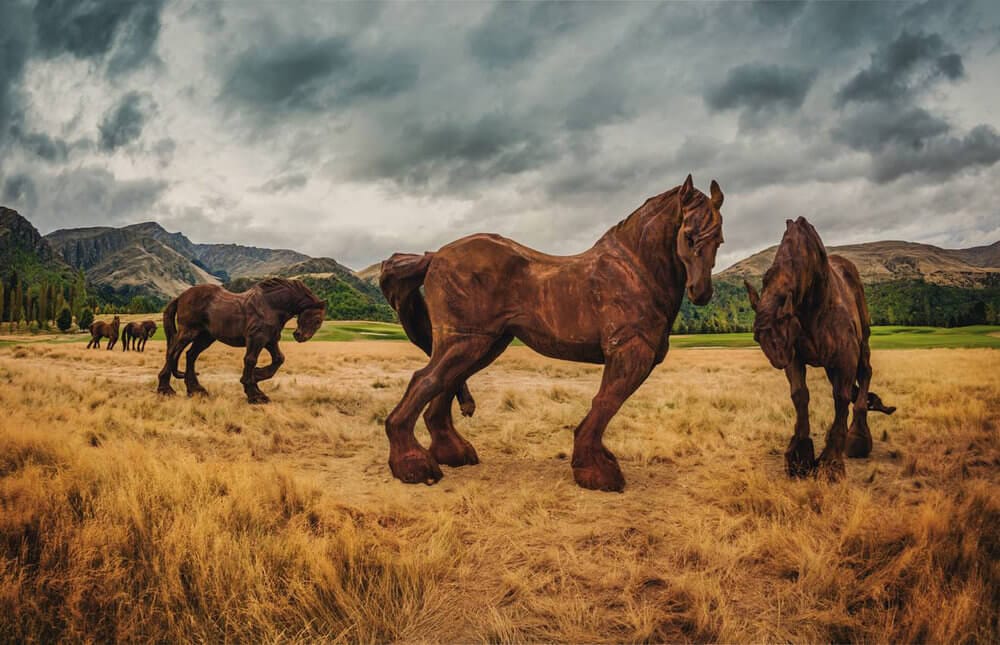 Iron horse sculptures line a fairway