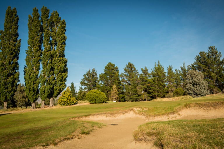 Large bunker leads to raised green