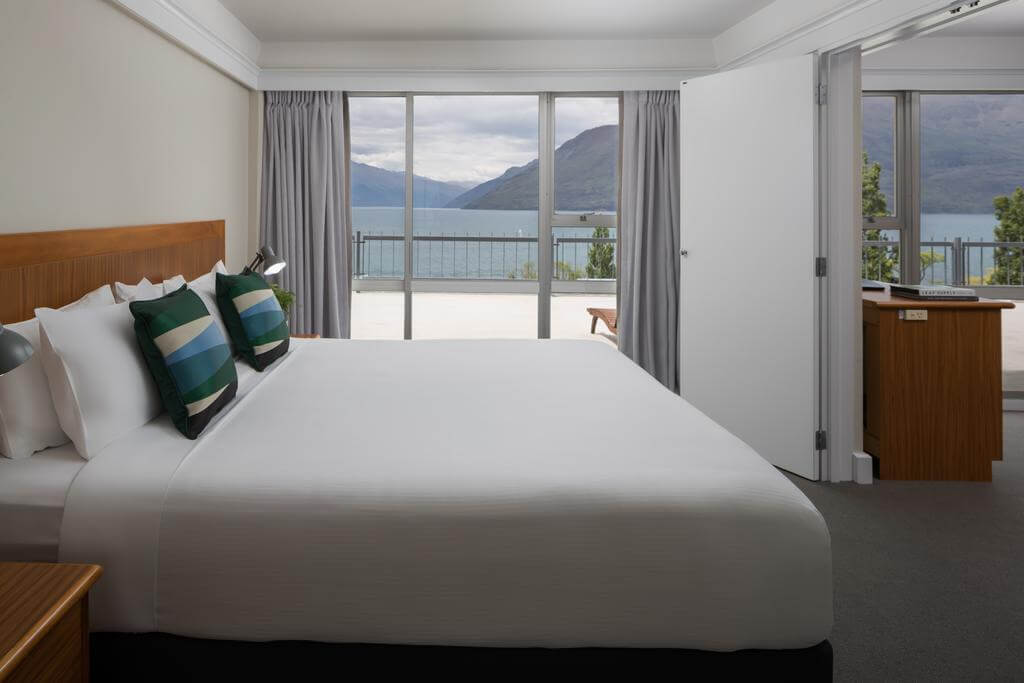 Double bed in a junior suite overlooking Lake Wakatipu