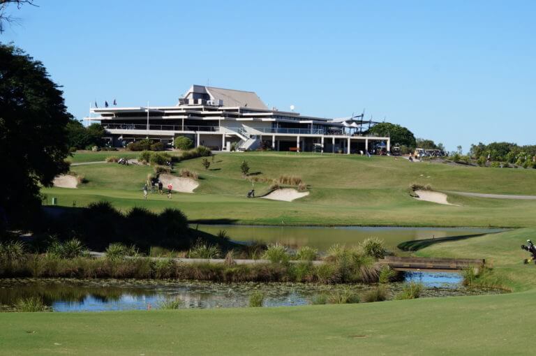 Golfers play in front of Indooroopilly clubhouse