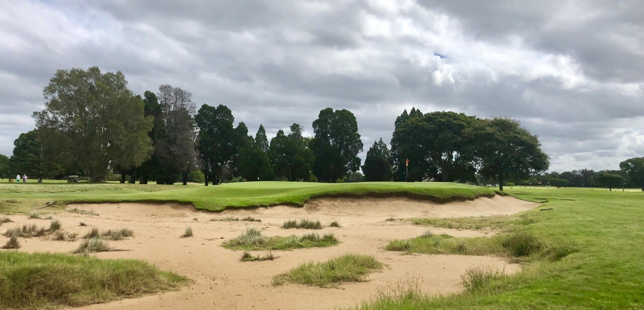 Bunkers frame the raised seventeenth green