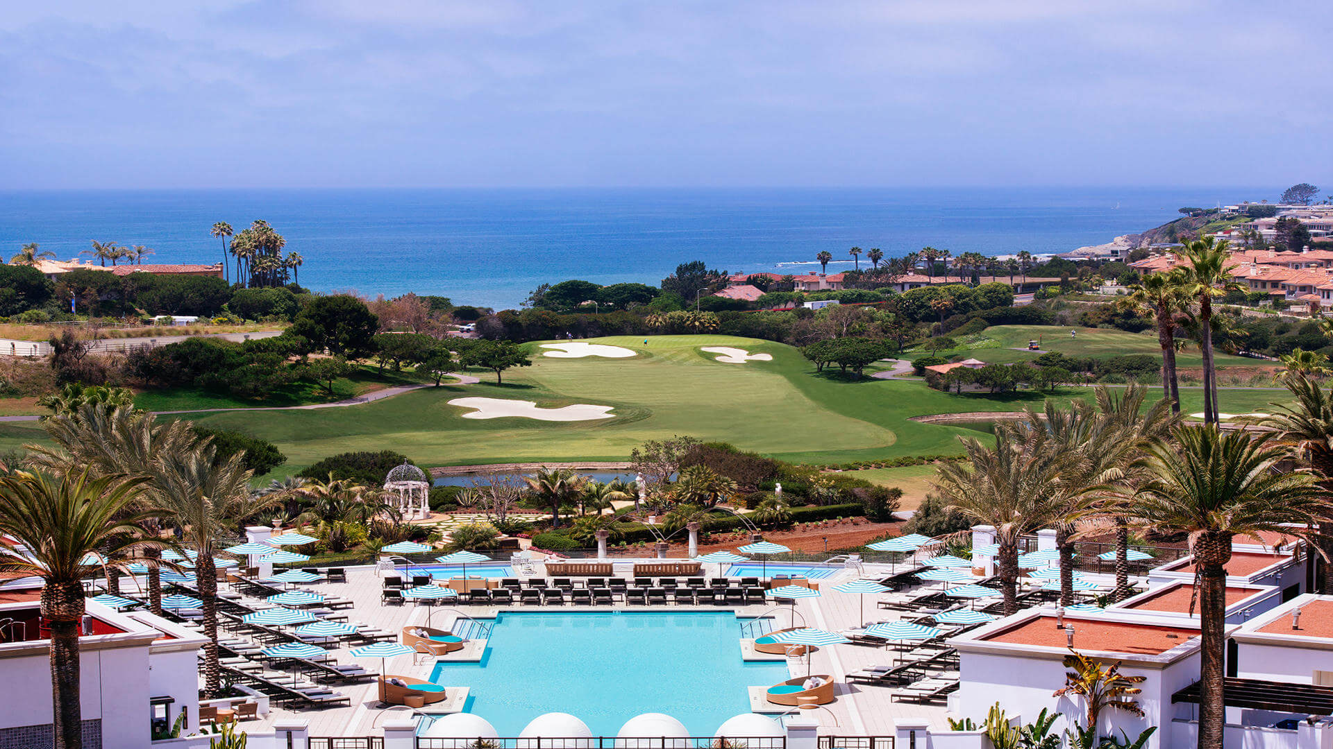 Resort pool overlooking golf course and Pacific Ocean
