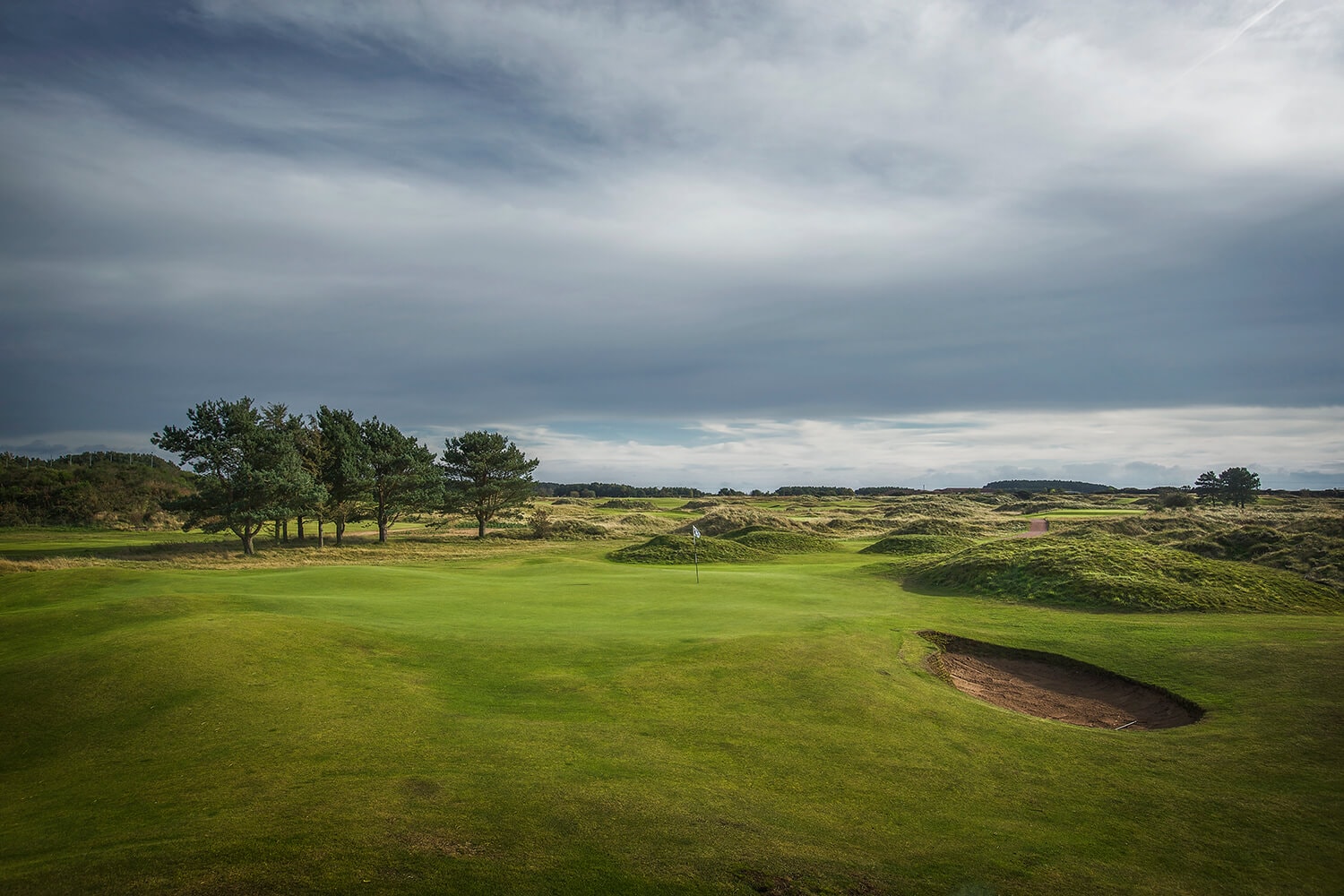 Grey sky contrasts with green fairways at Panmure's ninth hole