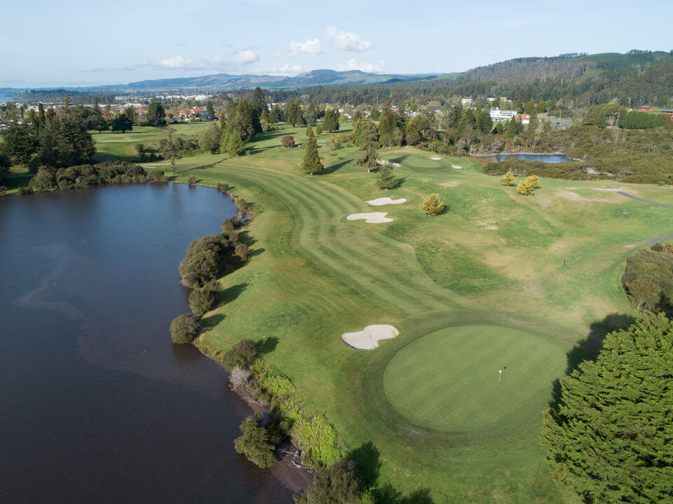 Fifteenth green adjacent to a large lake at Rotorua golf course