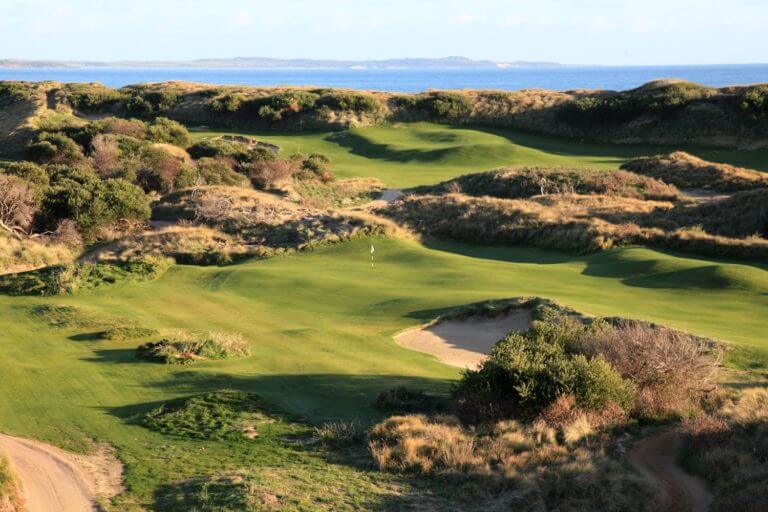 Undulating links golf course amid large sand dunes