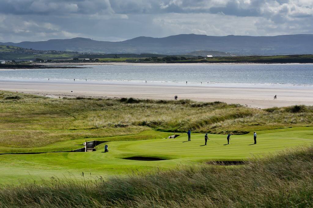 Golfers on county Sligo golf course fifteenth hole