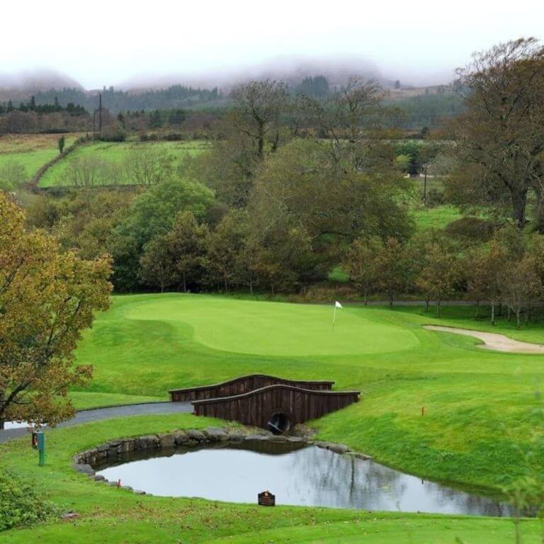 Par three golf hole and lake at Castle Dargan Resort