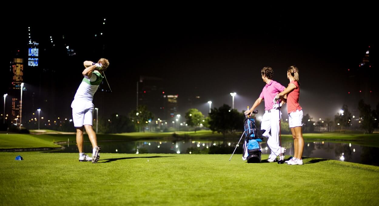 Golfers play The Faldo Course at night