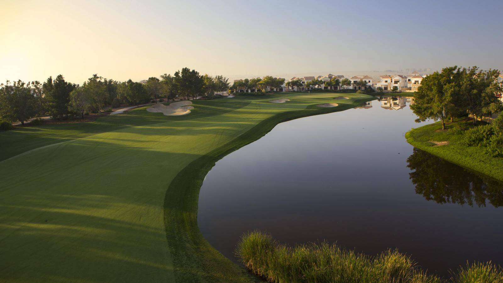Tranquil lake and tee boxes on Jumeirah Golf Estates Earth Course