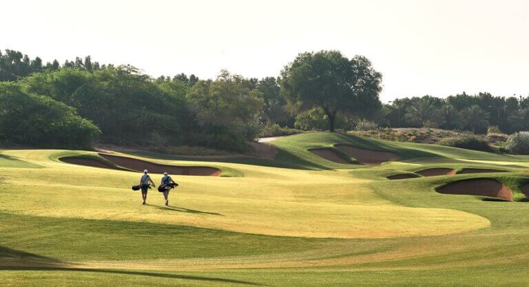 Golfers play the fire course at Jumeirah Golf Estates