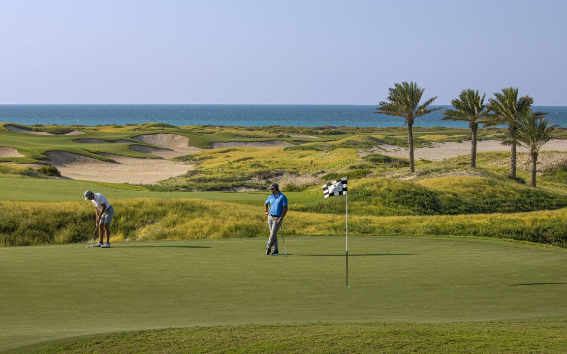 Golfers play Saadiyat Beach club
