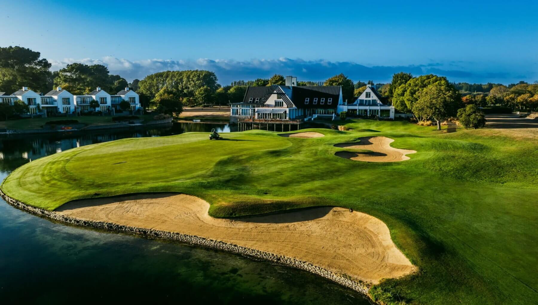 Aerial view of golf course next to water