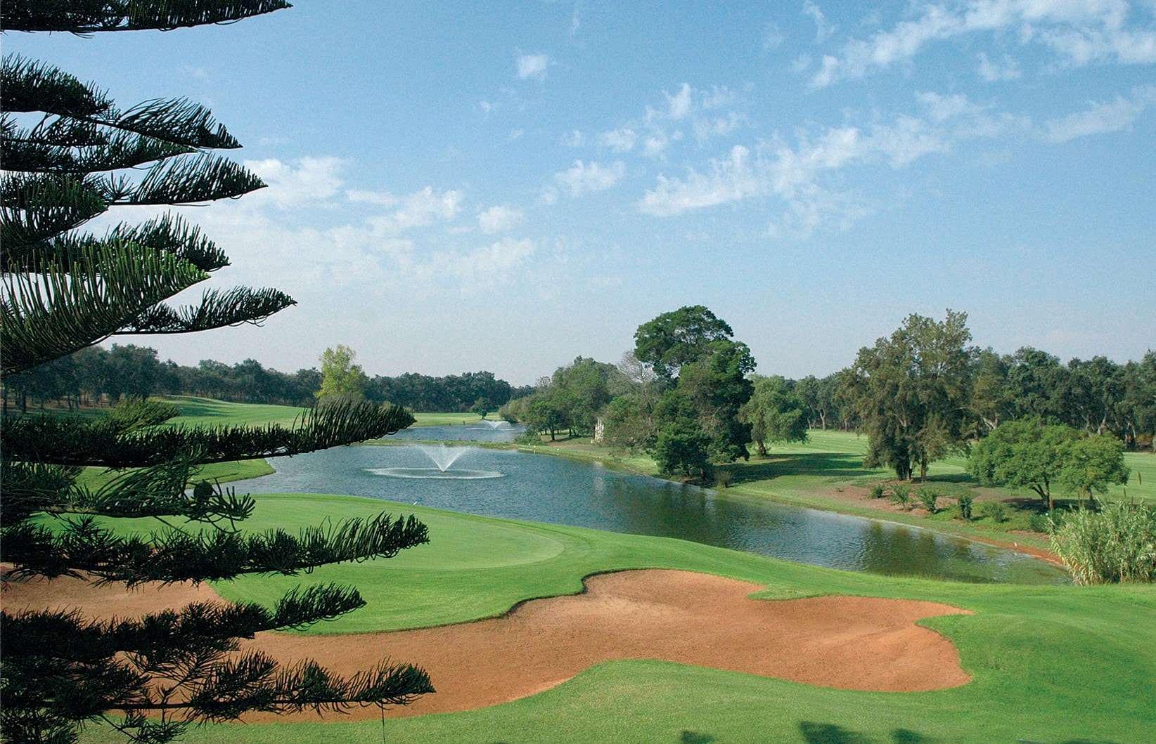 Overlooking fountains and red-sand bunkers at Royal Golf Dar Es Salam