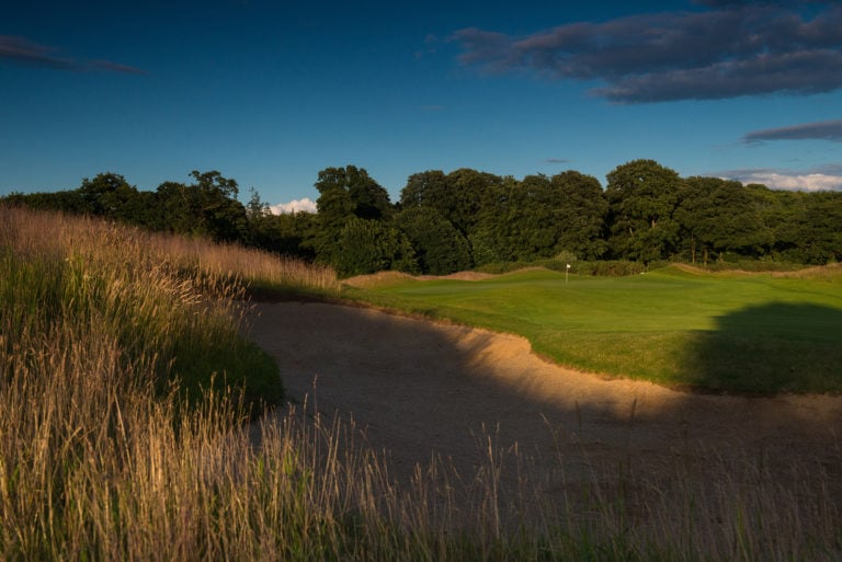 Looking at the 7th hole green surrounded by a bunker, Castlemartyr Resort, Cork, Ireland