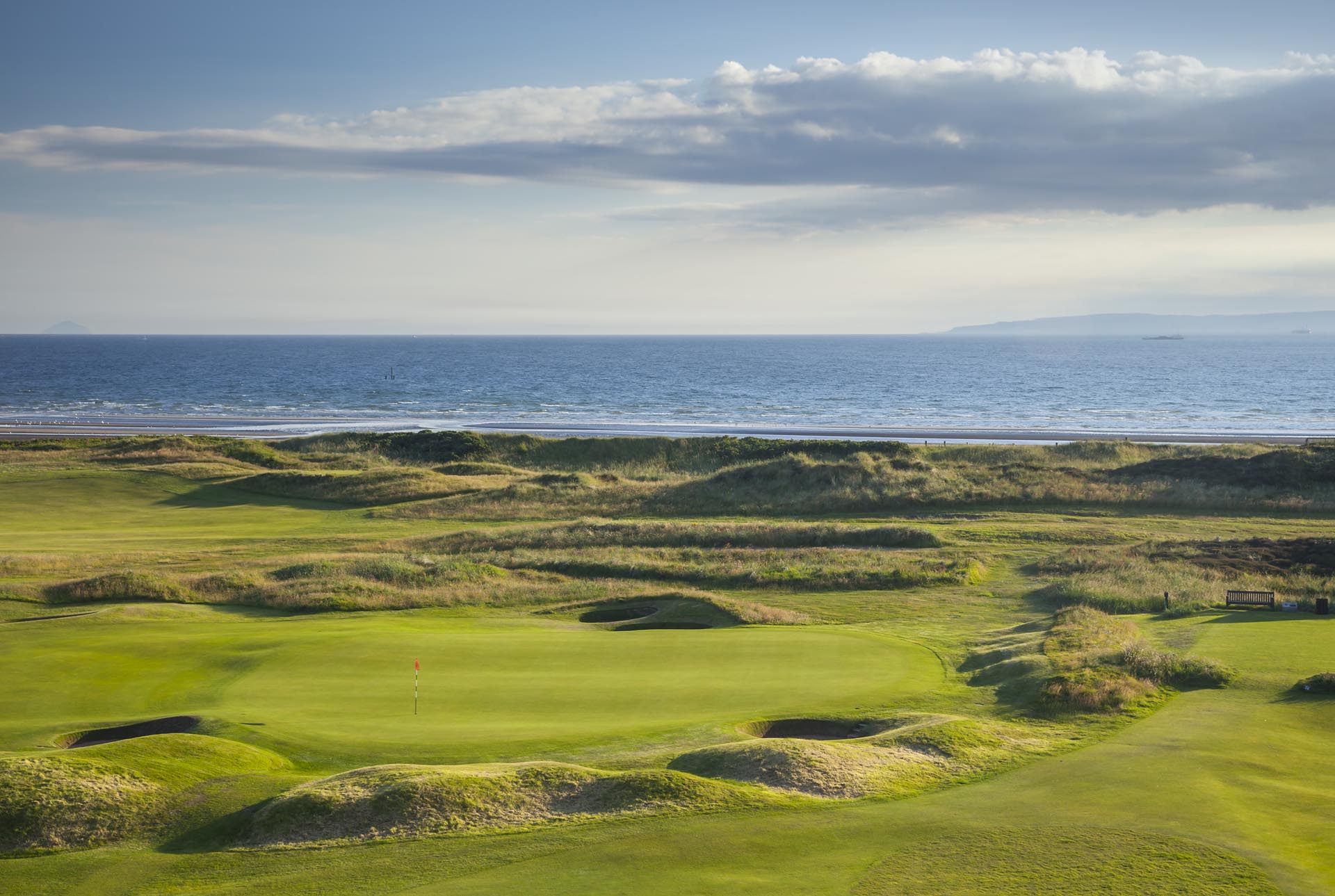 The green fairways contrast with the sea at The Western Gailes Golf Club, Ayrshire, Scotland, United Kingdom
