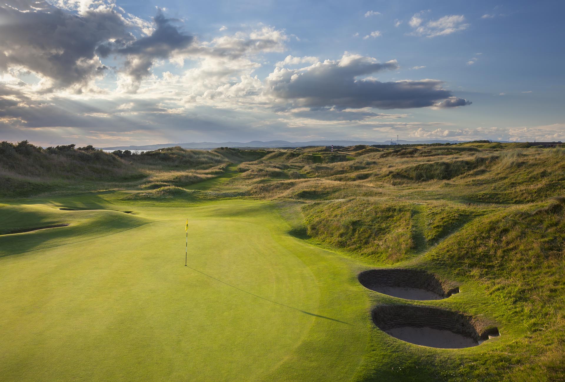 Viewing a valley amongst undulating grassy hills at The Western Gailes Golf Club, Ayrshire, Scotland, United Kingdom