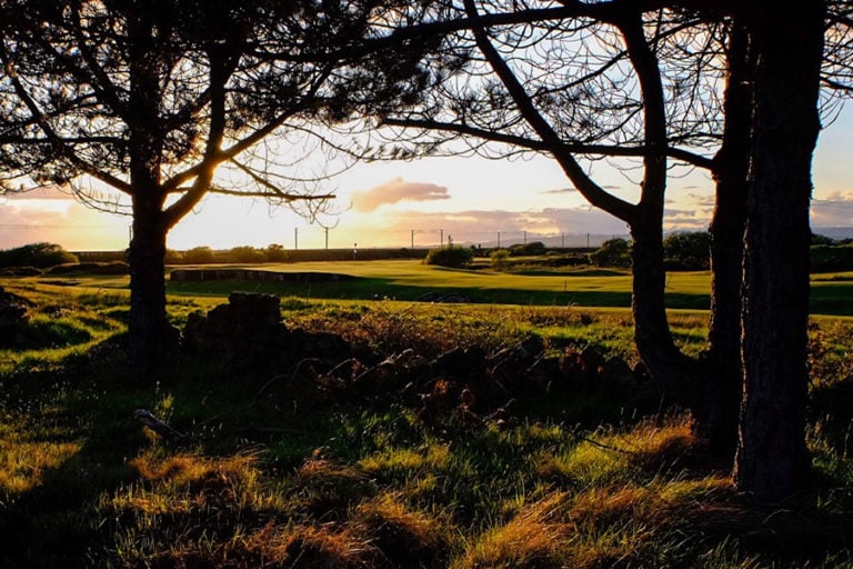View from the trees at sunset over the 13th at Kilmarnock Barrassie Links, Troon, Scotland, United Kingdom