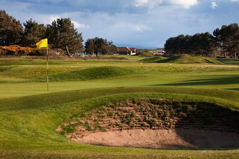 Displaying a vertical wall in a bunker at Kilmarnock Barrassie Links, Troon, Scotland, United Kingdom
