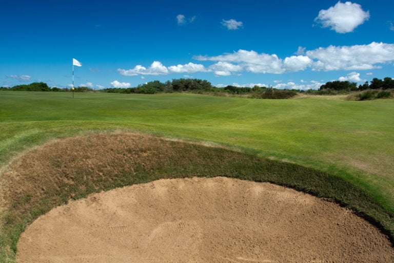 View from a pot bunker shows a difficult approach to the green at Gailes Links, Ayrshire, Scotland, United Kingdom