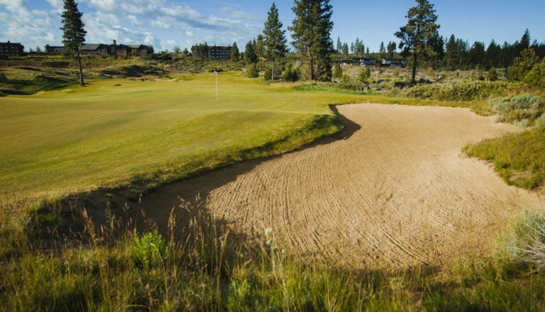 Image of the 1st green looking back toward the resort at Tetherow Resort, Bend, Oregon, USA