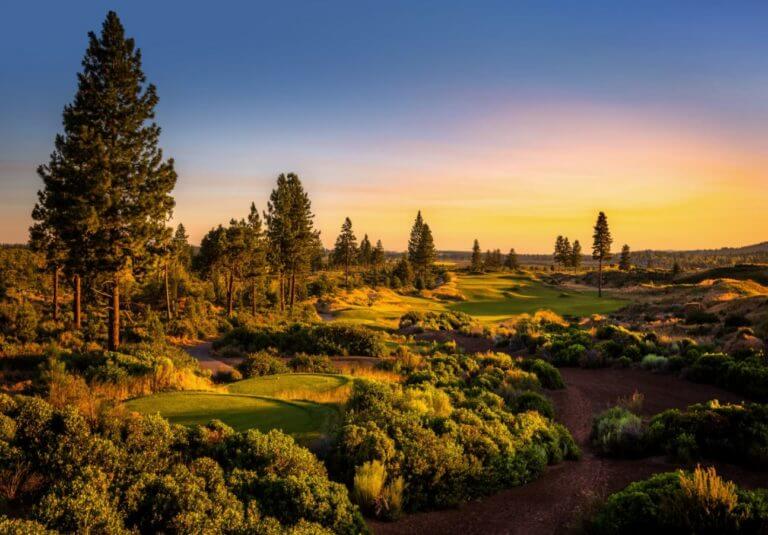 Image displaying the setting sun on the 1st tee box of the golf course at Tetherow Resort, Bend, Oregon, USA