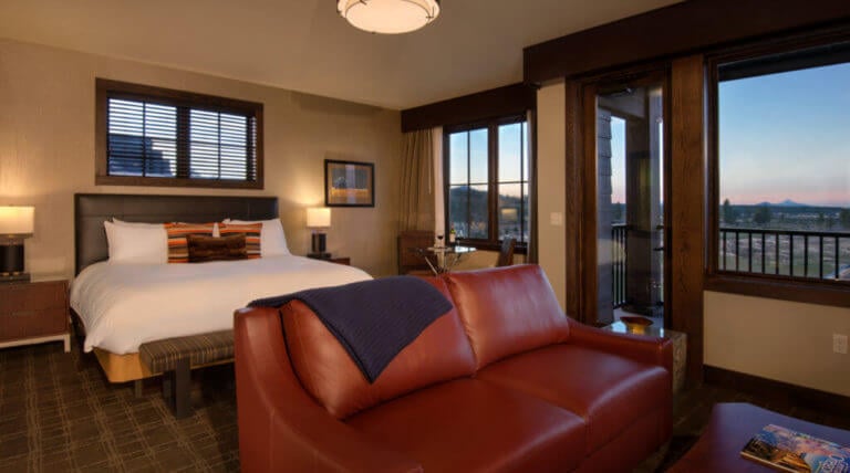 Image of a king bed in a deluxe room looking out to the golf course, Tetherow Resort, Bend, Oregon, USA