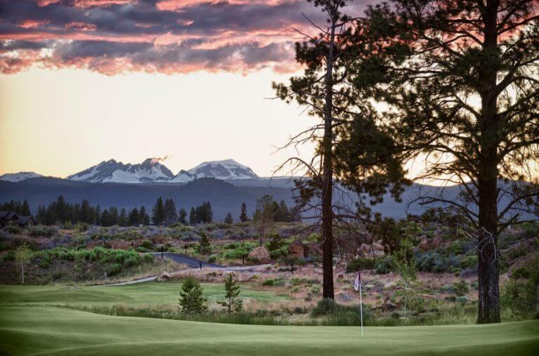 Image of a golf hole and distant mountain range at Tetherow Resort, Bend, Oregon, USA