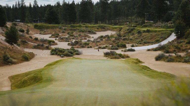 Image of a green looking back toward the tee boxes on the golf course at Tetherow Resort, Bend, Oregon, USA