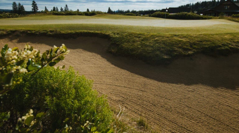 Image of a pristine bunker next to a green on the golf course at Tetherow Resort, Bend, Oregon, USA
