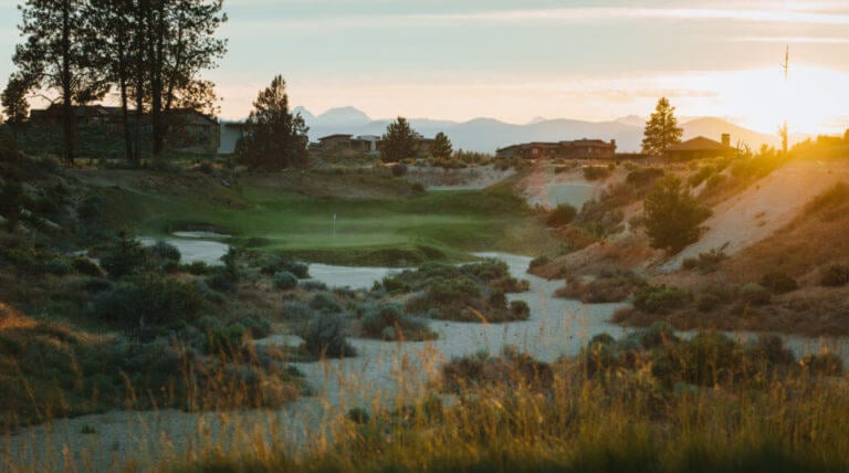 Image of the setting sun making a valley dark on the golf course at Tetherow Resort, Bend, Oregon, USA