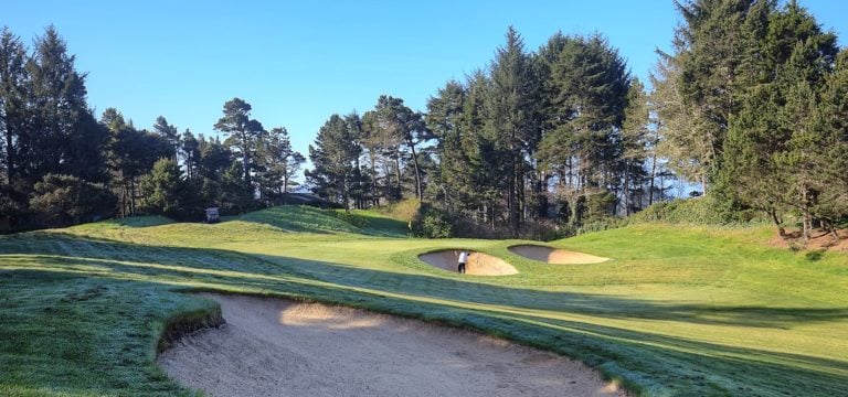 Image displaying a golfer in a bunker on the Salishan Golf Course, Oregon, USA