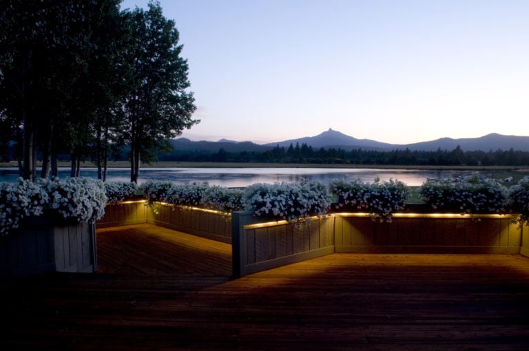 Twilight image of The Lodge Deck and distant mountains at Black Butte Ranch, Oregon, USA
