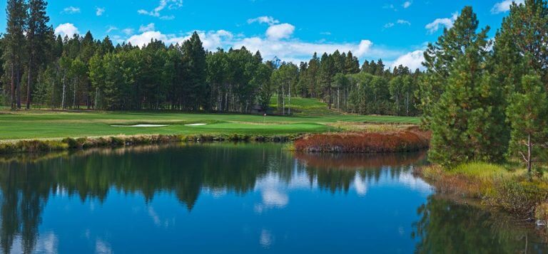 Image of the Glaze Meadow Golf Course across a lake Black Butte Ranch, Oregon, USA