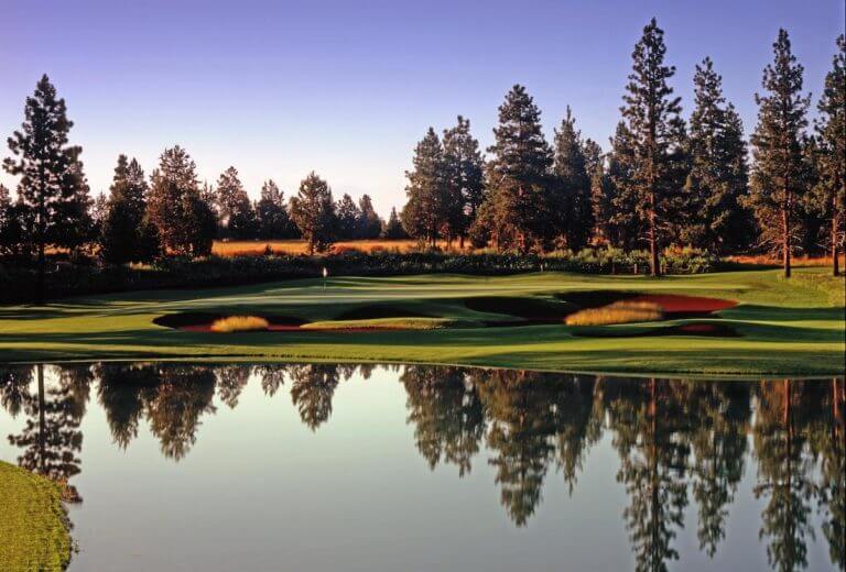 Image of a still lake on the 6th hole of the Aspen Lakes Golf Course, Sisters, Oregon, USA