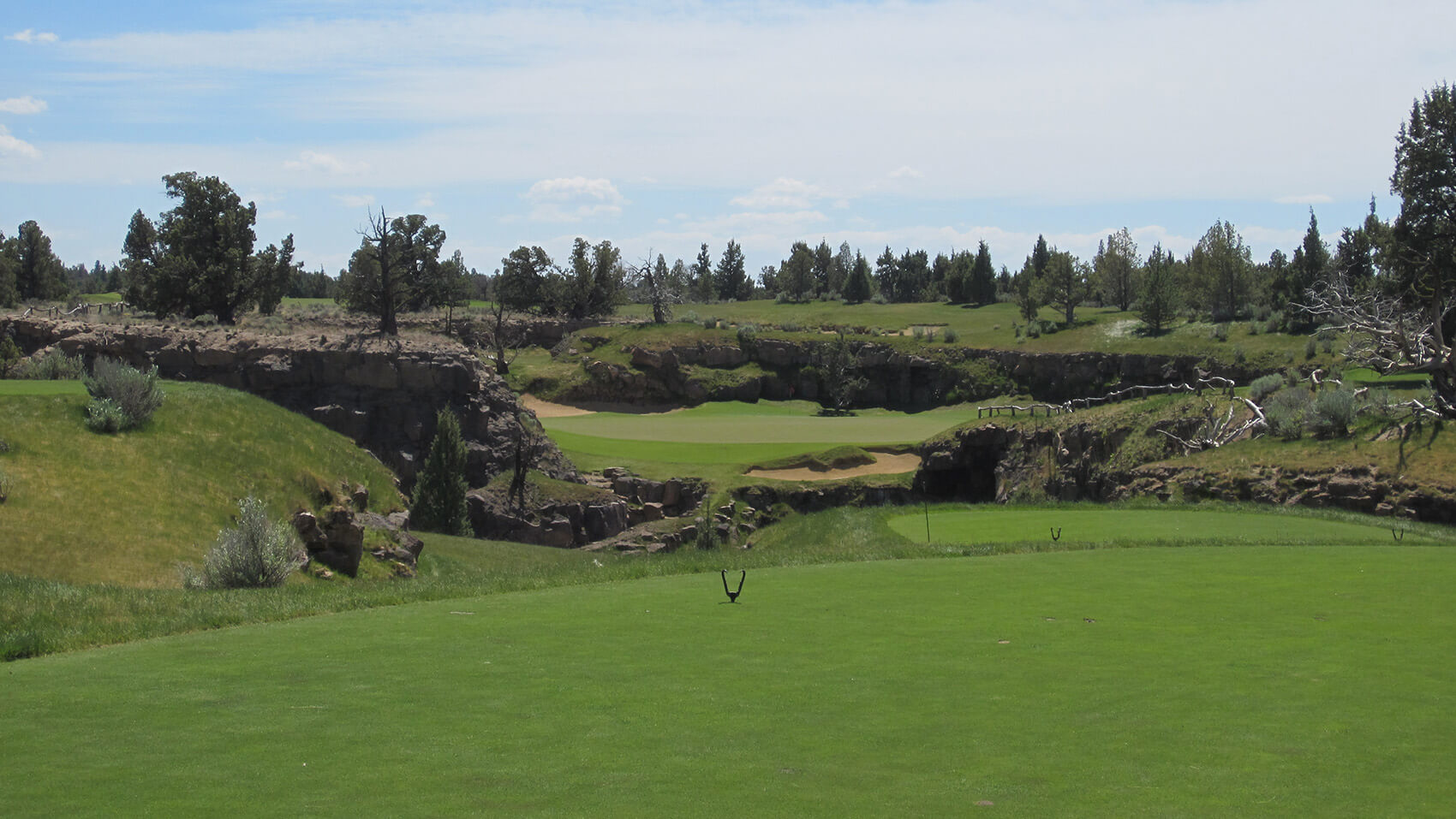 Looking at the signature hole par-3 8th on the Tom Fazio Golf Course at Pronghorn Resort, Bend, Oregon, USA