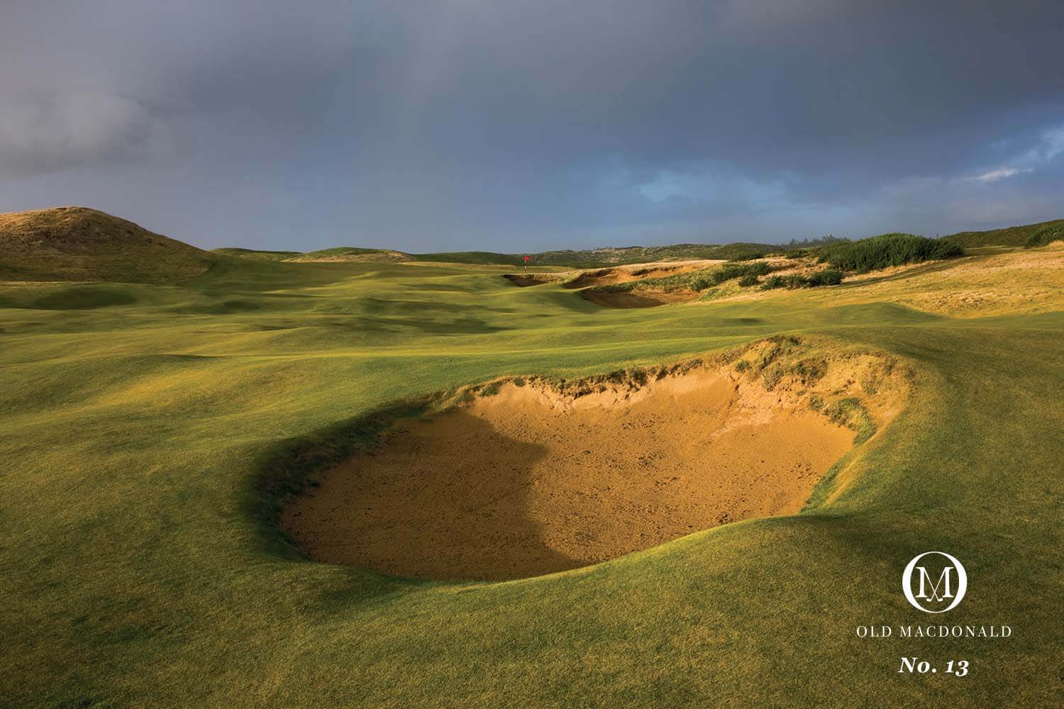 Image of a pot bunker and distant rainbow on the 13th hole of the Old Macdonald Golf Course, Bandon Dunes Golf Resort, Oregon, USA