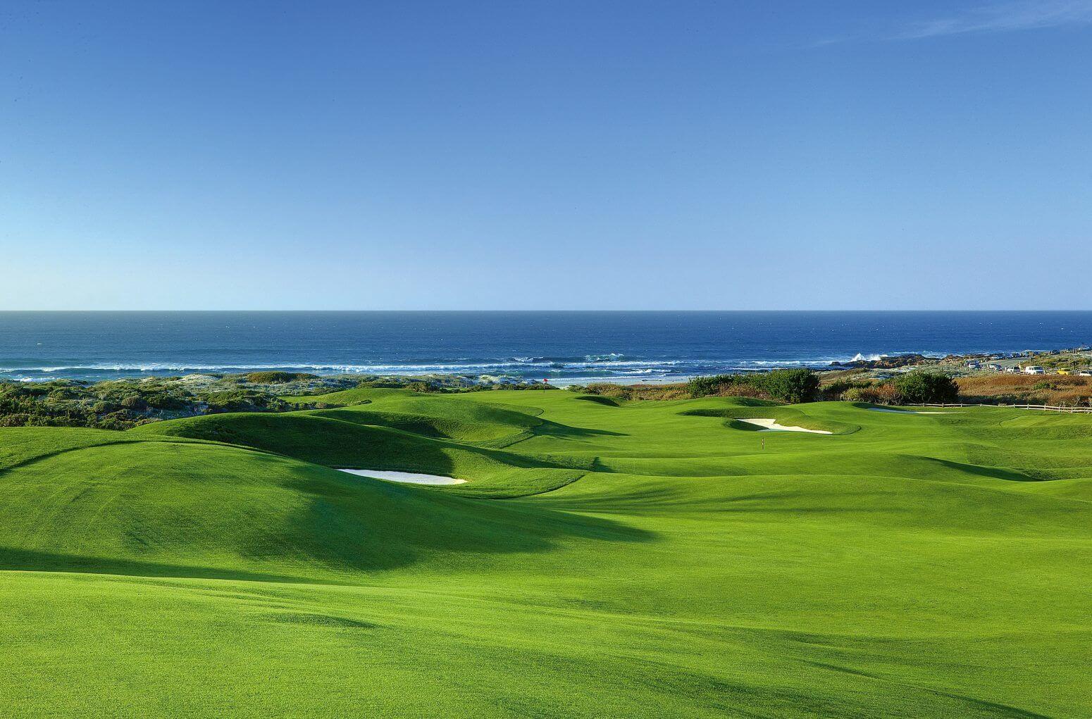 Image of the green of the golf course contrasted with the blue of the Pacific, The Links at Spanish Bay, Pebble Beach, California, USA