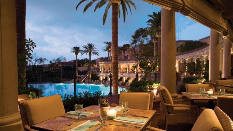 Image of the Coliseum dining area overlooking the pool, Pelican Hill Resort, Newport, California, USA