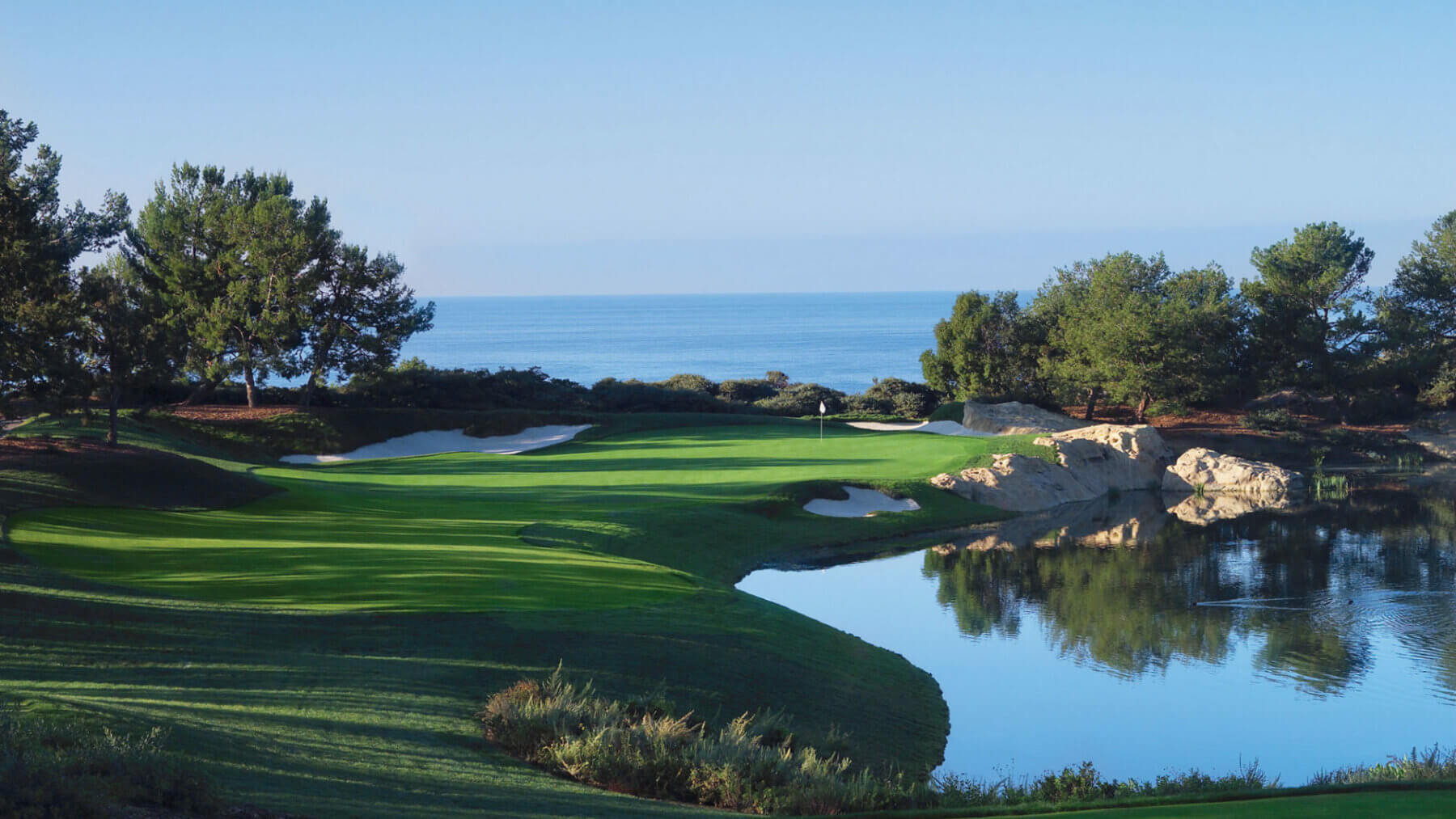 Image of a lake andocean surrounding a par 3 at Pelican Hill Resort, Newport, California, USA