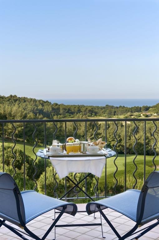 Image of breakfast on a balcony overlooking the golf course and distant Mediterranean, Hôtel Dolce Frégate Provence
