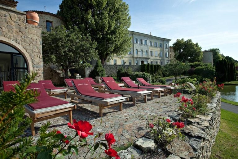 Lounge seats are placed in front of Chateau de Taulane, France.