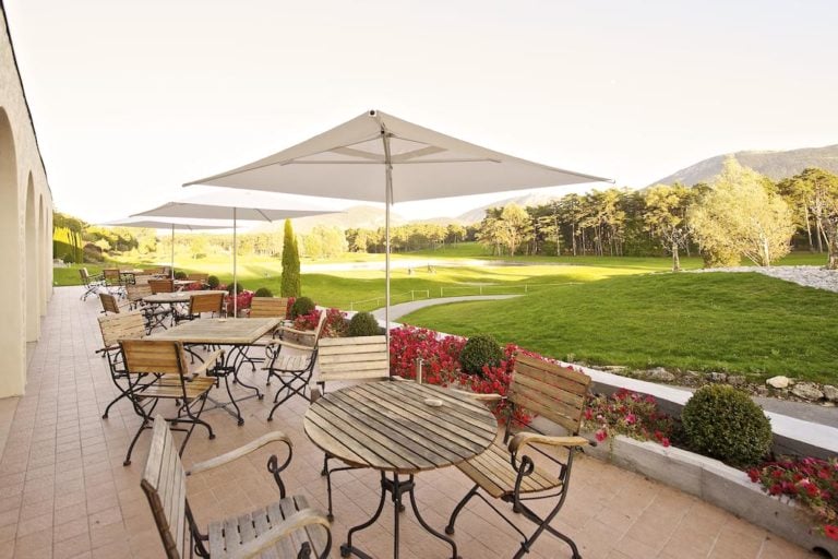 Umbrella's offer shade for meals on the patio at Chateau de Taulane, France.