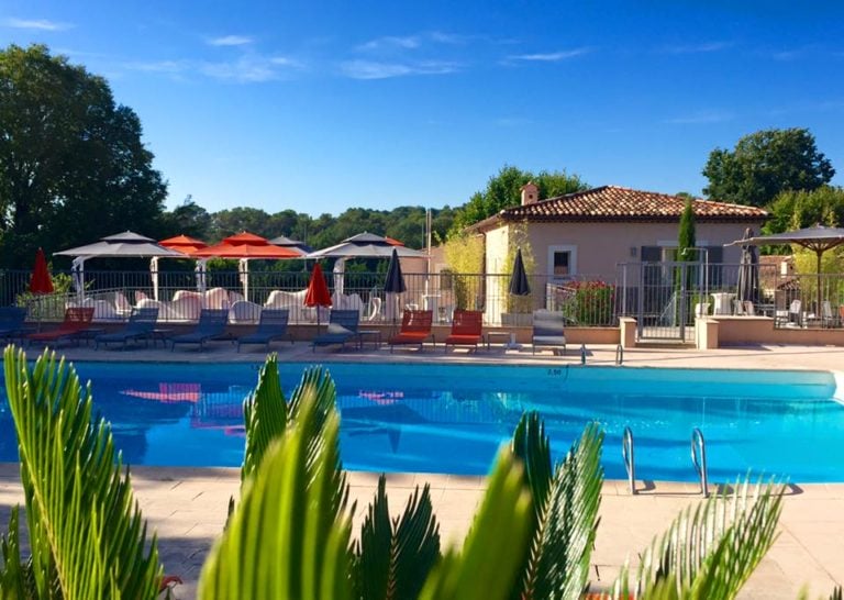 View of the pool and resort building in background at Chateau De La Bégude , French Riviera, France