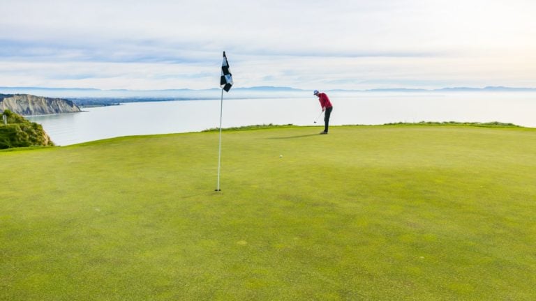 A player putts on the golf course at Cape Kidnappers, Hawke's Bay, New Zealand