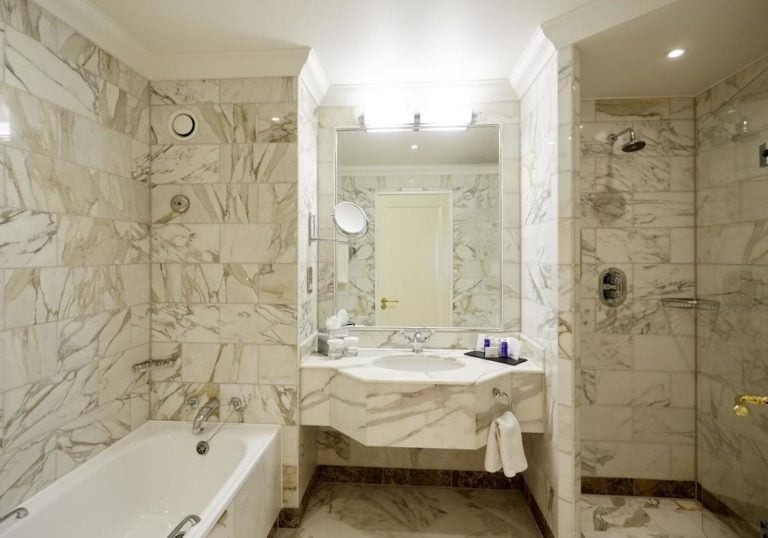 Displaying the marble interior of a guest-room bathroom, The Celtic Manor Resort, Usk Valley, Wales, United Kingdom